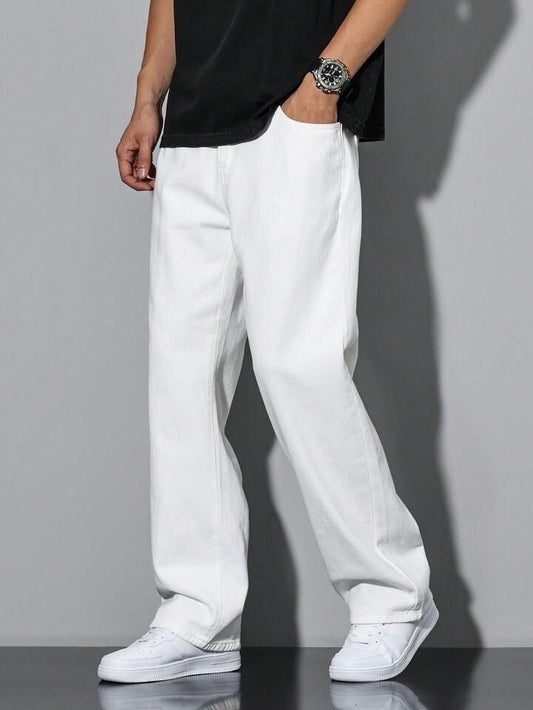 Person wearing white pants and a black shirt against a gray background